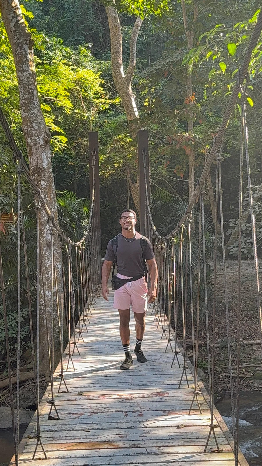 Elijah Naylor walking across a suspension bridge